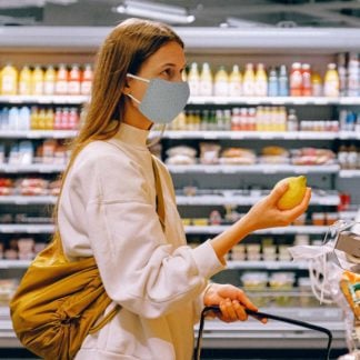 Woman grocery shopping wearing Kinder PPE Mask